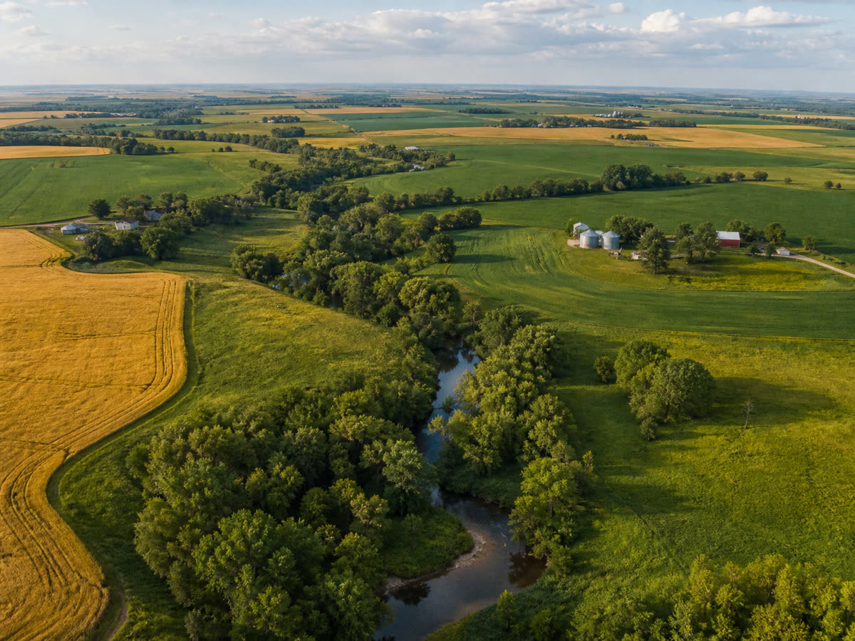 Aerial view of Eastern Nebraska countryside with a creek and farmsteads